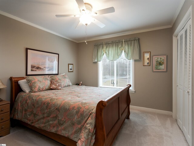 bedroom featuring a closet, light carpet, and ornamental molding