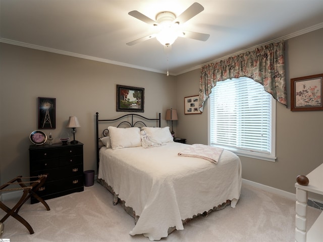 bedroom featuring ornamental molding, a ceiling fan, baseboards, and light carpet