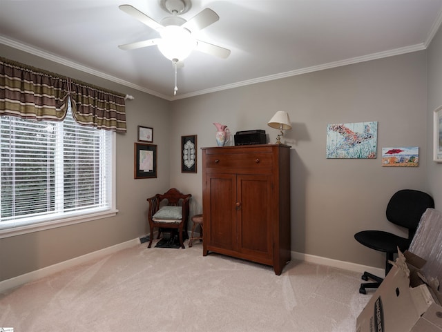 sitting room featuring a ceiling fan, light colored carpet, baseboards, and ornamental molding