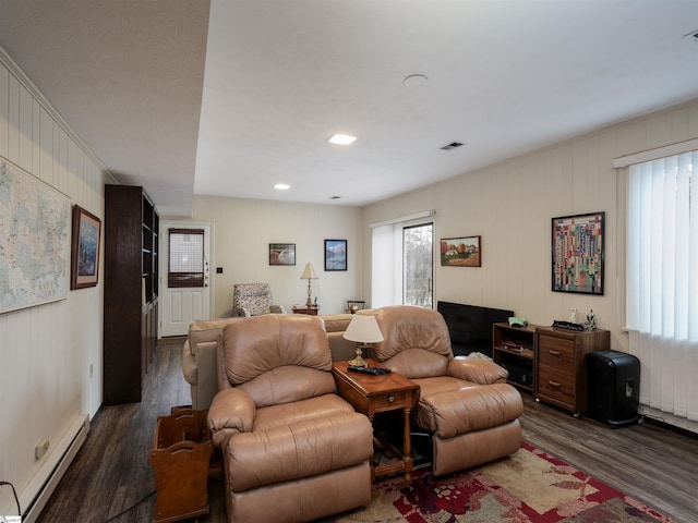 living area featuring a baseboard radiator, visible vents, and dark wood-style flooring