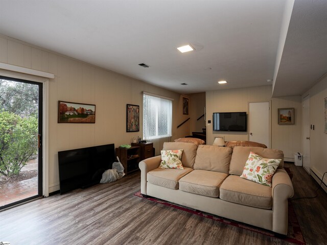 living room featuring a wealth of natural light, visible vents, and wood finished floors