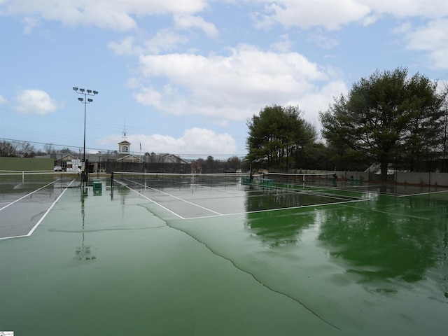 view of sport court featuring fence