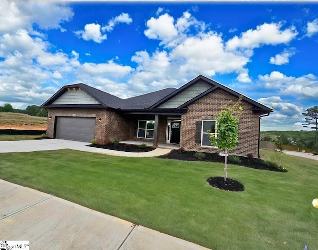 view of front of house with brick siding, a garage, concrete driveway, and a front lawn