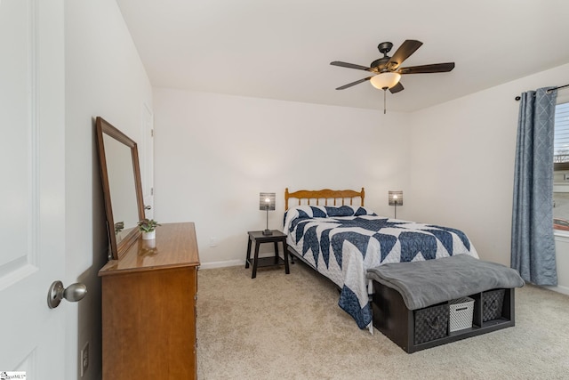 bedroom featuring baseboards, light carpet, and a ceiling fan