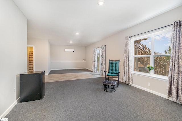 unfurnished room with carpet, baseboards, and a wealth of natural light