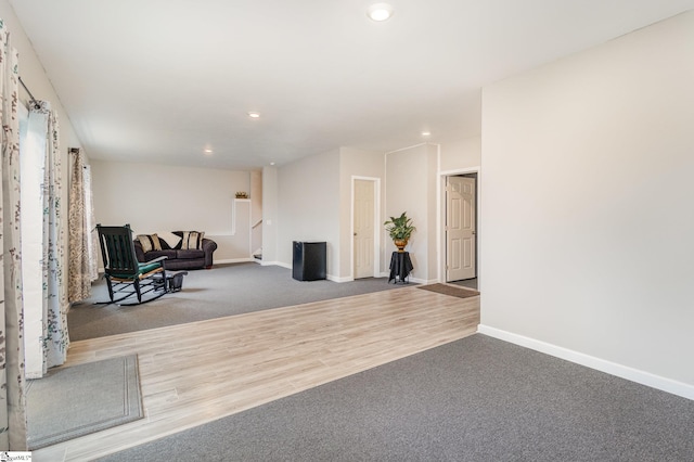 sitting room featuring recessed lighting, baseboards, carpet, and wood finished floors