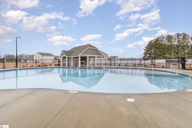 community pool featuring a patio and fence