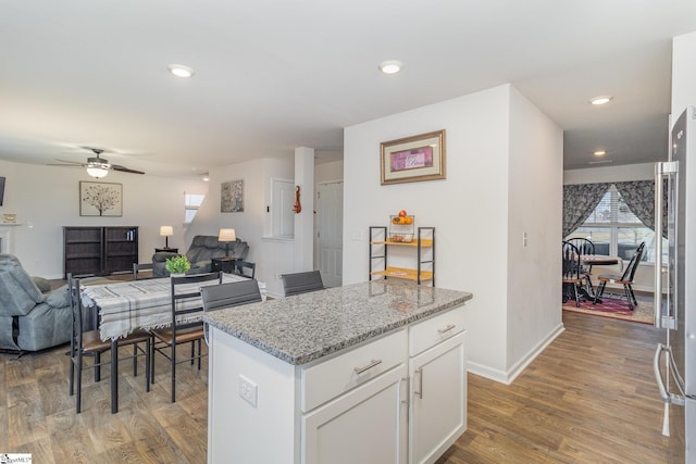 kitchen with white cabinets, a healthy amount of sunlight, and light wood-style floors