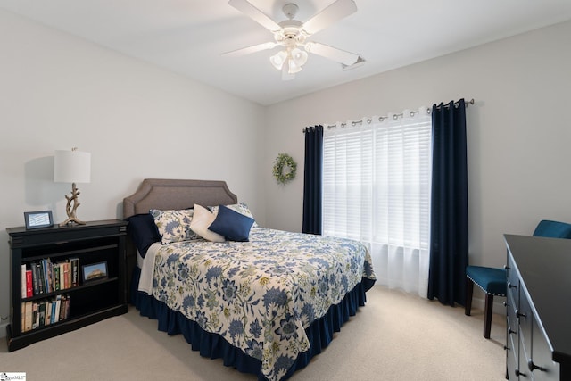 bedroom with light colored carpet and a ceiling fan