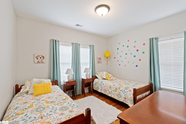 bedroom with wood finished floors and visible vents