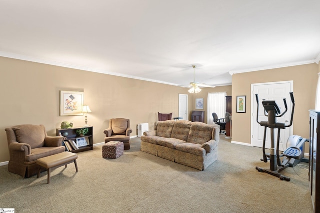 living room with a ceiling fan, crown molding, baseboards, and carpet floors