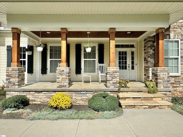 property entrance featuring stone siding and a porch