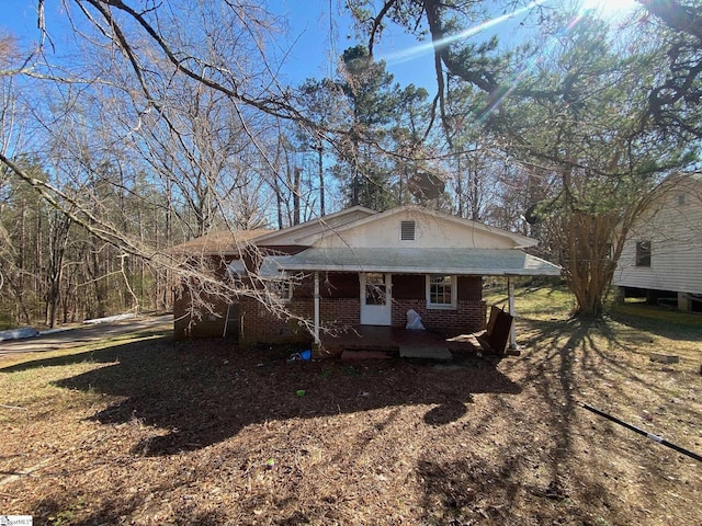 bungalow-style home with brick siding and a porch