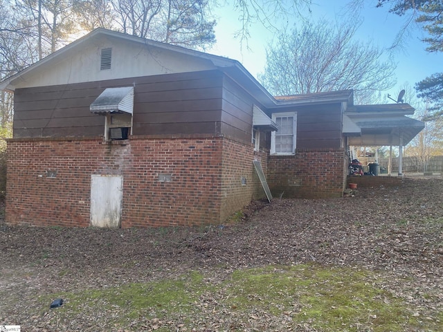 view of side of property featuring brick siding