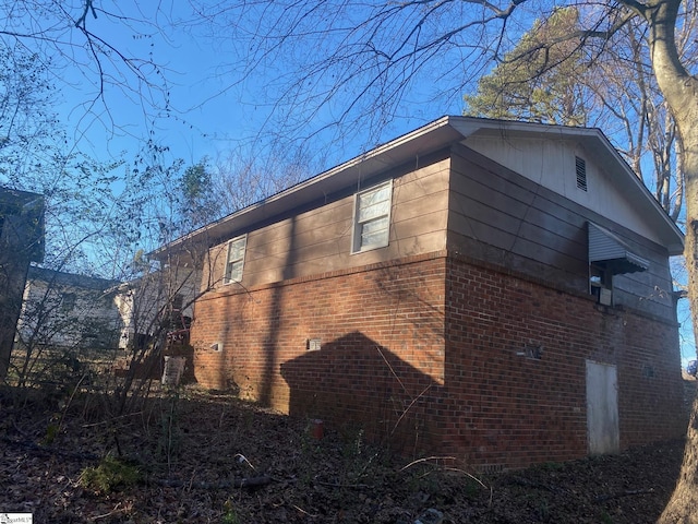 view of property exterior featuring brick siding