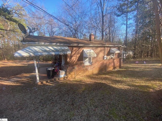 view of side of property with brick siding and a chimney