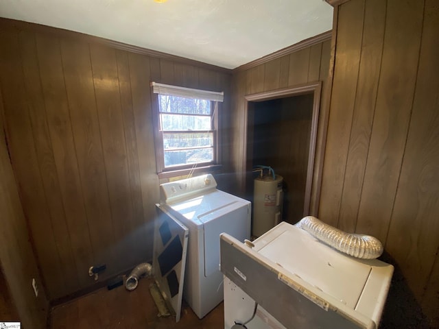 washroom featuring washer and dryer, laundry area, wood walls, and electric water heater