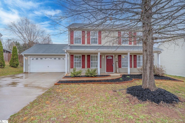 traditional-style house featuring a front lawn, covered porch, concrete driveway, and an attached garage