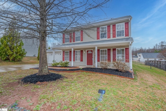 traditional-style home featuring fence, an attached garage, covered porch, a front lawn, and concrete driveway