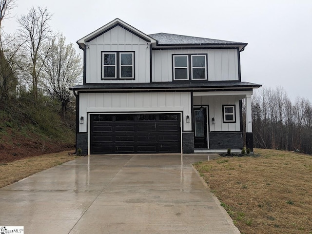 modern inspired farmhouse featuring an attached garage, board and batten siding, and driveway