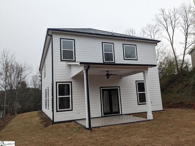 back of property with a patio, a lawn, and ceiling fan