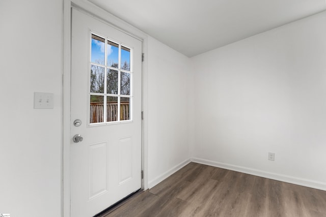 doorway to outside with dark wood finished floors and baseboards