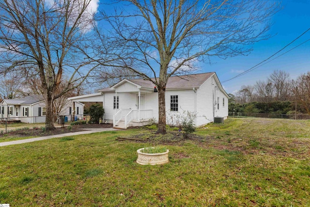 view of front of property featuring a front yard, cooling unit, and fence