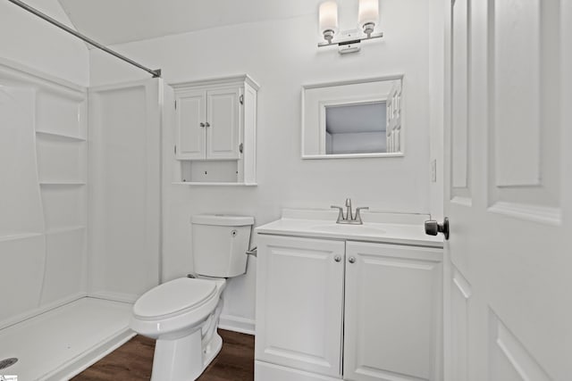 full bath with a shower stall, toilet, vanity, and wood finished floors