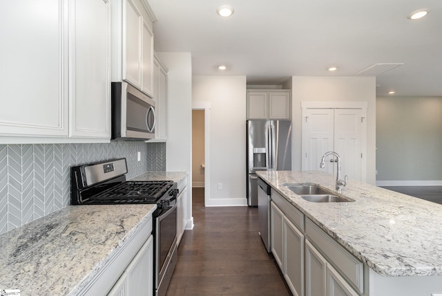 kitchen with a sink, decorative backsplash, appliances with stainless steel finishes, and recessed lighting