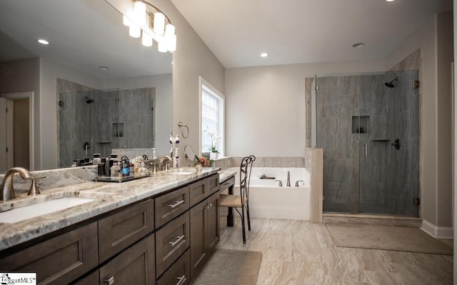 bathroom featuring a sink, double vanity, a bath, and a shower stall