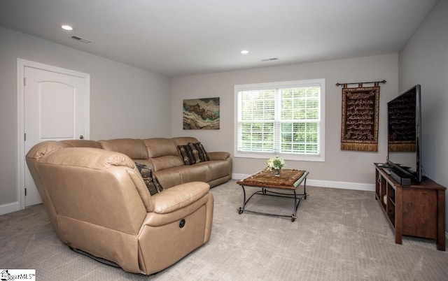 living room featuring recessed lighting, light colored carpet, visible vents, and baseboards