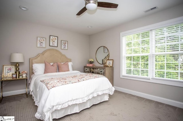 bedroom with a ceiling fan, baseboards, visible vents, and carpet floors