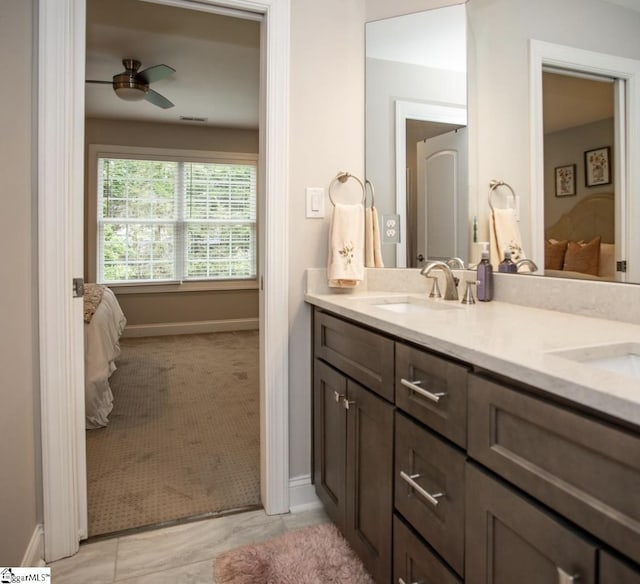 ensuite bathroom featuring a sink, a ceiling fan, double vanity, and ensuite bathroom