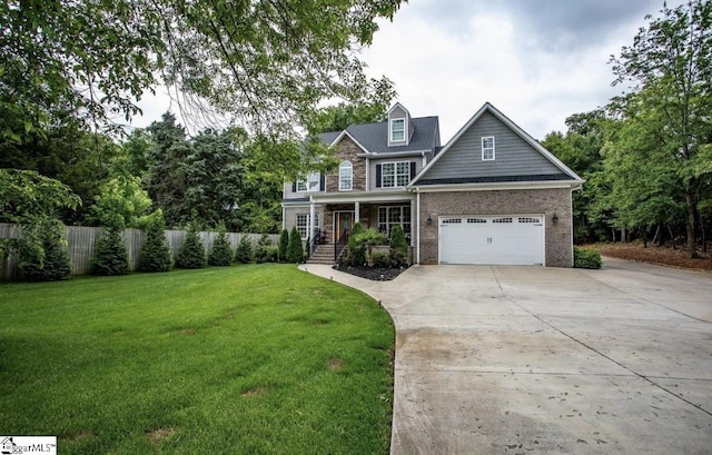 view of front of property with a garage, driveway, a front lawn, and fence