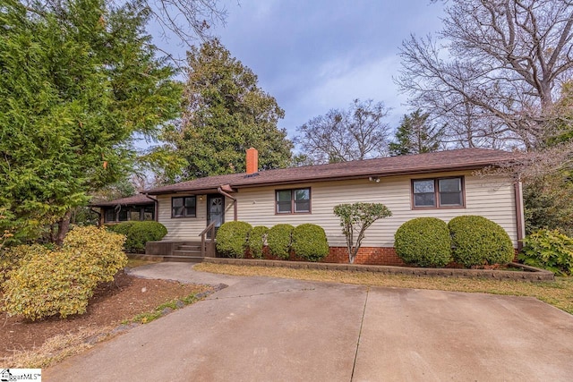 single story home featuring a chimney