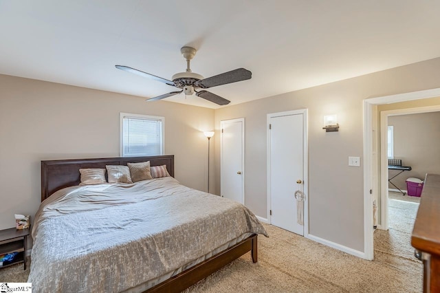 bedroom with baseboards, light colored carpet, and a ceiling fan