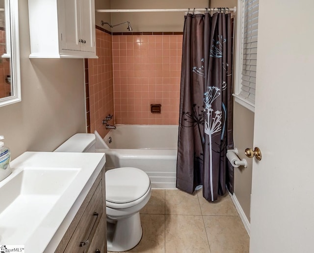 bathroom with tile patterned floors, shower / bath combo with shower curtain, toilet, and vanity