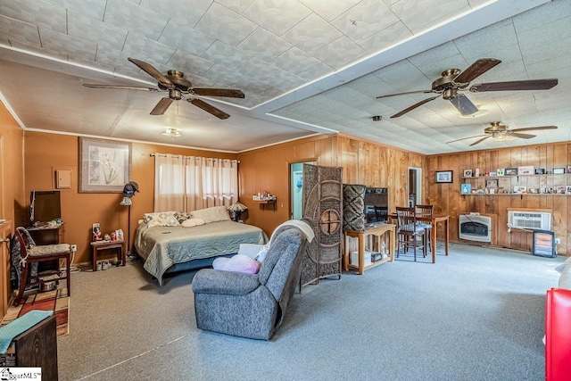 carpeted bedroom featuring heating unit, wooden walls, and an AC wall unit