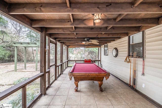 rec room with ceiling fan, wooden ceiling, beamed ceiling, and log walls