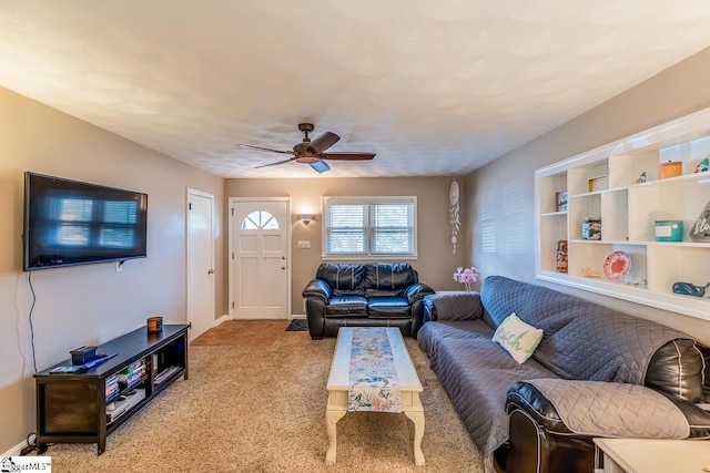 living room featuring baseboards, carpet floors, and ceiling fan