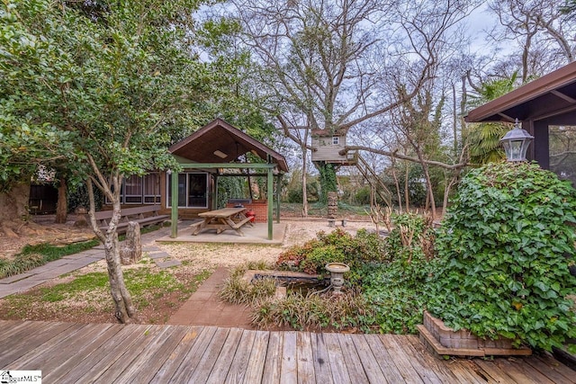 view of yard featuring a deck and a patio