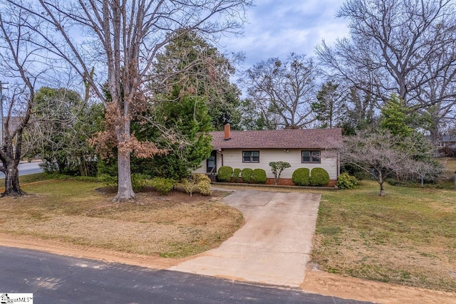 view of front of house with a chimney and a front lawn