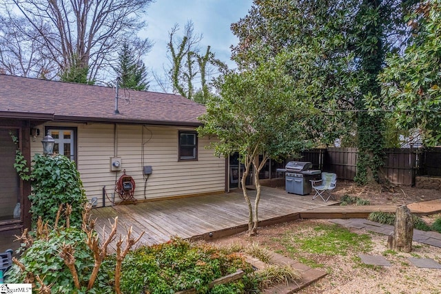 deck featuring area for grilling and fence