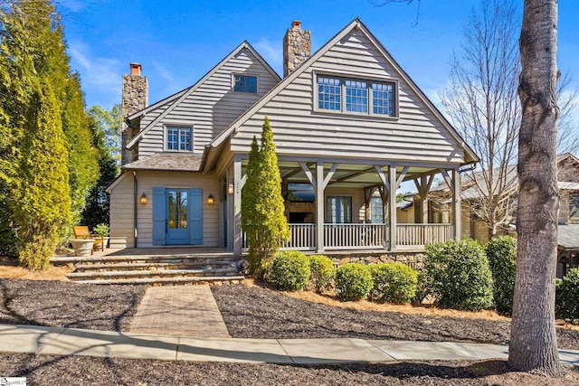 view of front of house with covered porch and a chimney