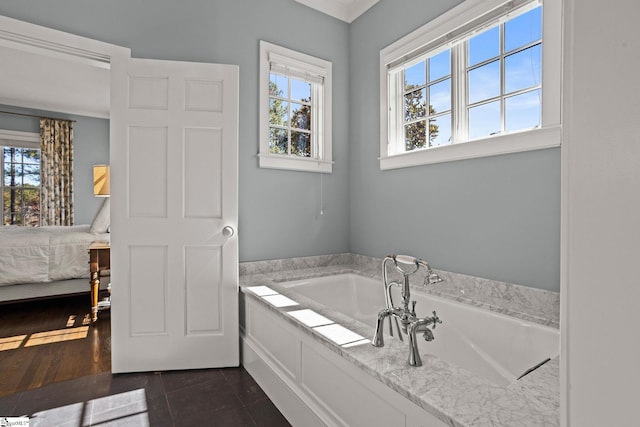 bathroom with tile patterned floors, a bath, a wealth of natural light, and connected bathroom