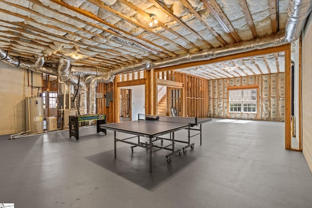 game room featuring water heater and concrete floors