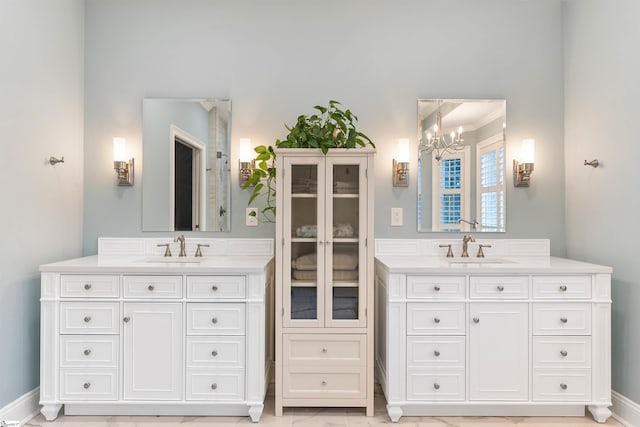 full bathroom featuring a sink, two vanities, and an inviting chandelier