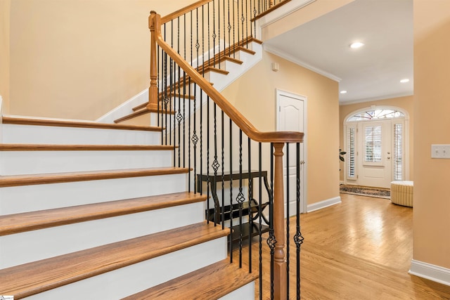 stairs featuring crown molding, recessed lighting, wood finished floors, and baseboards