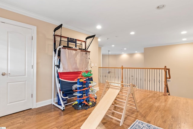 recreation room with visible vents, baseboards, ornamental molding, recessed lighting, and wood finished floors