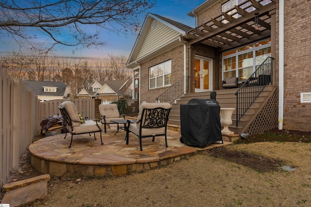 view of patio with stairs, french doors, a fenced backyard, a grill, and a pergola